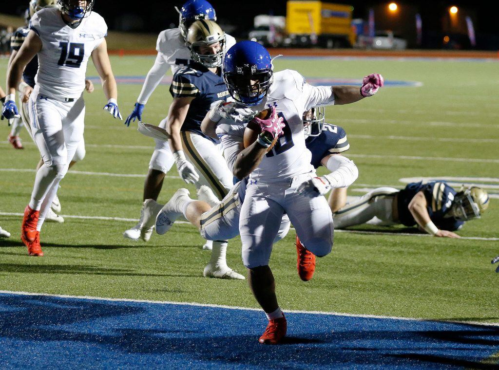 Trinity Christian's Emari Matthews (18) scores a touchdown as he is tackled by Austin Regents  THomas Scully (22) during the first half of play at the TAPPS Division II State Championship game at Waco Midway's Panther Stadium in Hewitt, Texas on Friday, December 6, 2019. (Vernon Bryant/The Dallas Morning News)