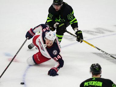 Columbus Blue Jackets center Cole Sillinger (34) slips to the ice as Dallas Stars right wing...
