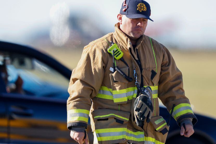 Firefighters and police respond to a midair collision Saturday at Dallas Executive Airport.