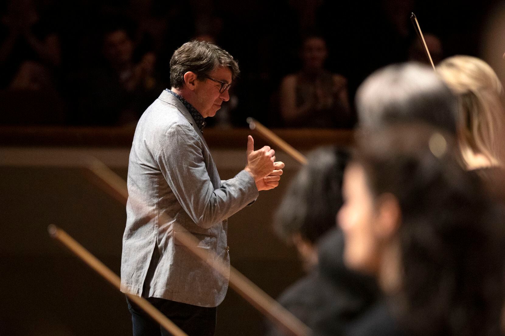 Composer Donnacha Dennehy acknowledges the Dallas Symphony Orchestra and audience at the...