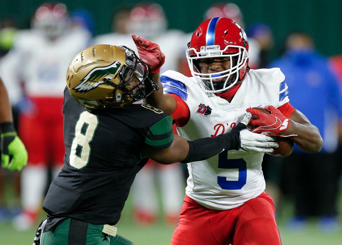 Duncanville junior running back Malachi Medlock (5) battle DeSoto senior safety D'verryon Foster (8) for yardage during the first half of a Class 6A Division I Region II final high school football game, Saturday, January 2, 2021. (Brandon Wade/Special Contributor)