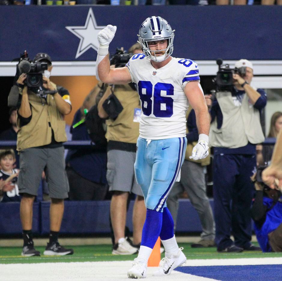 Dallas Cowboys tight end Dalton Schultz (86) signals his touchdown during the first half of a NFL football game against the Washington Football Team at AT&T Stadium in Arlington, TX on Sunday, December 26, 2021.