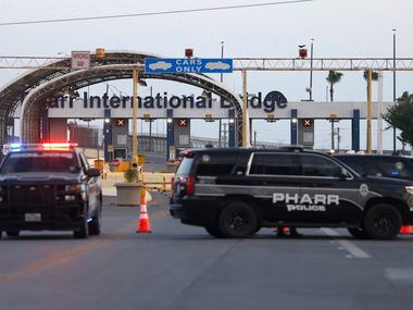 Pharr police officers sit at the Pharr–Reynosa International Bridge, which remained closed,...