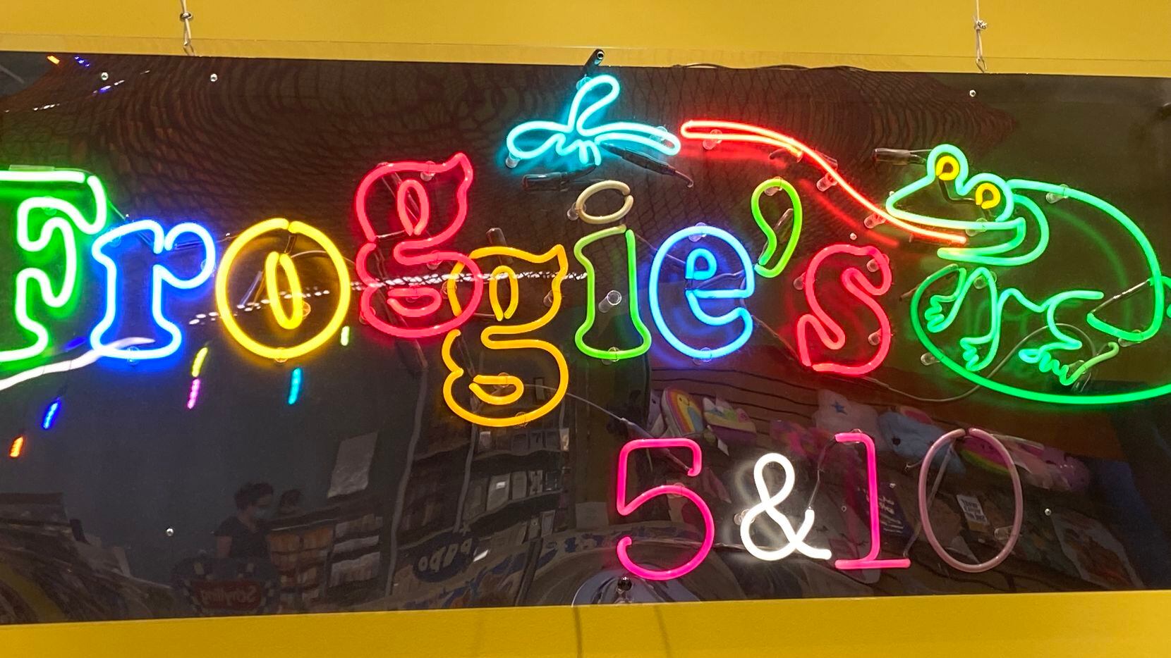 Froggie's neon sign from the longtime store on Knox Street hangs above the register at the...