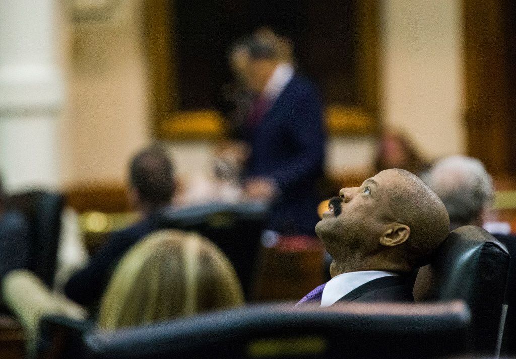 Sen. Borris Miles leans back in his chair during a midnight session during the third day of a special legislative session on Thursday at the Texas Capitol in Austin. The midnight session was called to read and pass the sunset bill.