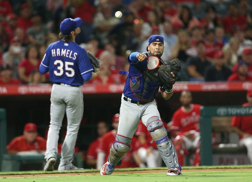 ANAHEIM, CA - SEPTEMBER 16:  Catcher Robinson Chirinos #61 of the Texas Rangers throws to...
