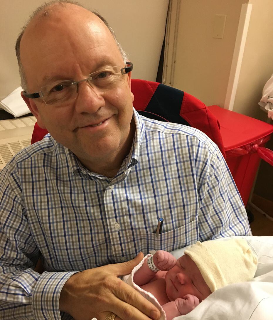 Walter Wilcox holding one of his grandchildren.
