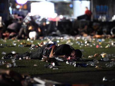 A person lies on the ground at the Route 91 Harvest country music festival after gunfire was...