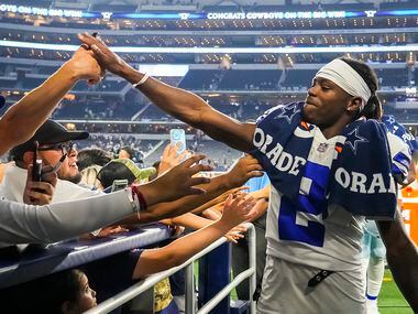 Dallas Cowboys wide receiver KaVontae Turpin high fives with fans as he leaves the field...