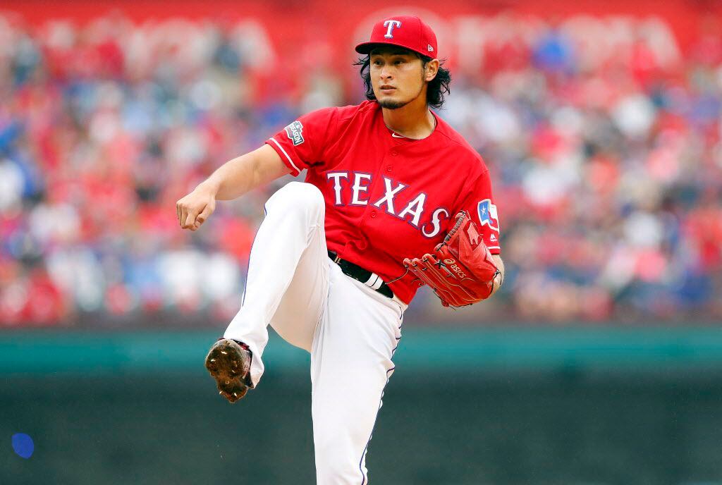 Texas Rangers starting pitcher Yu Darvish (11) follows through on a pitch to Toronto Blue...