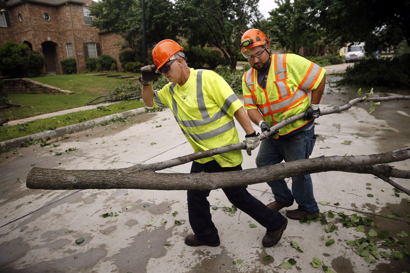 Fort Worth Park and Recreation crews clean up downed Bradford pear trees on Pendleton Dr. in North Fort Worth after winds toppled trees and tore shingles off homes, Wednesday, May 29, 2019. A tornado warned storm passed through the neighborhood near Heritage Trace Pkwy and N. Riverside Dr. 