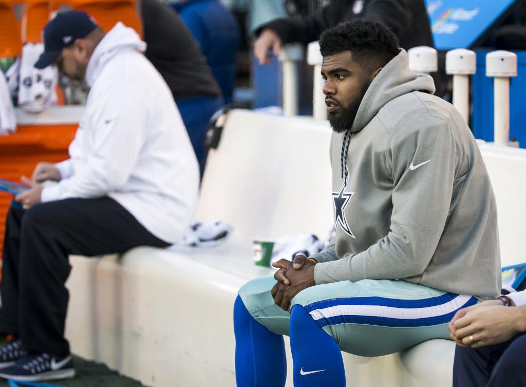 Dallas Cowboys running back Ezekiel Elliott sits on the bench during the second half of an...