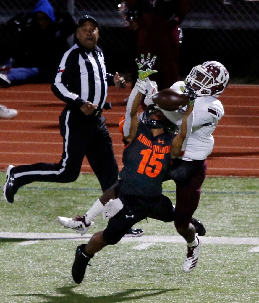 Rockwall DB PJ Barber (15) and Mesquite WR Ja'Darion Smith (1) battle for a pass that fell...