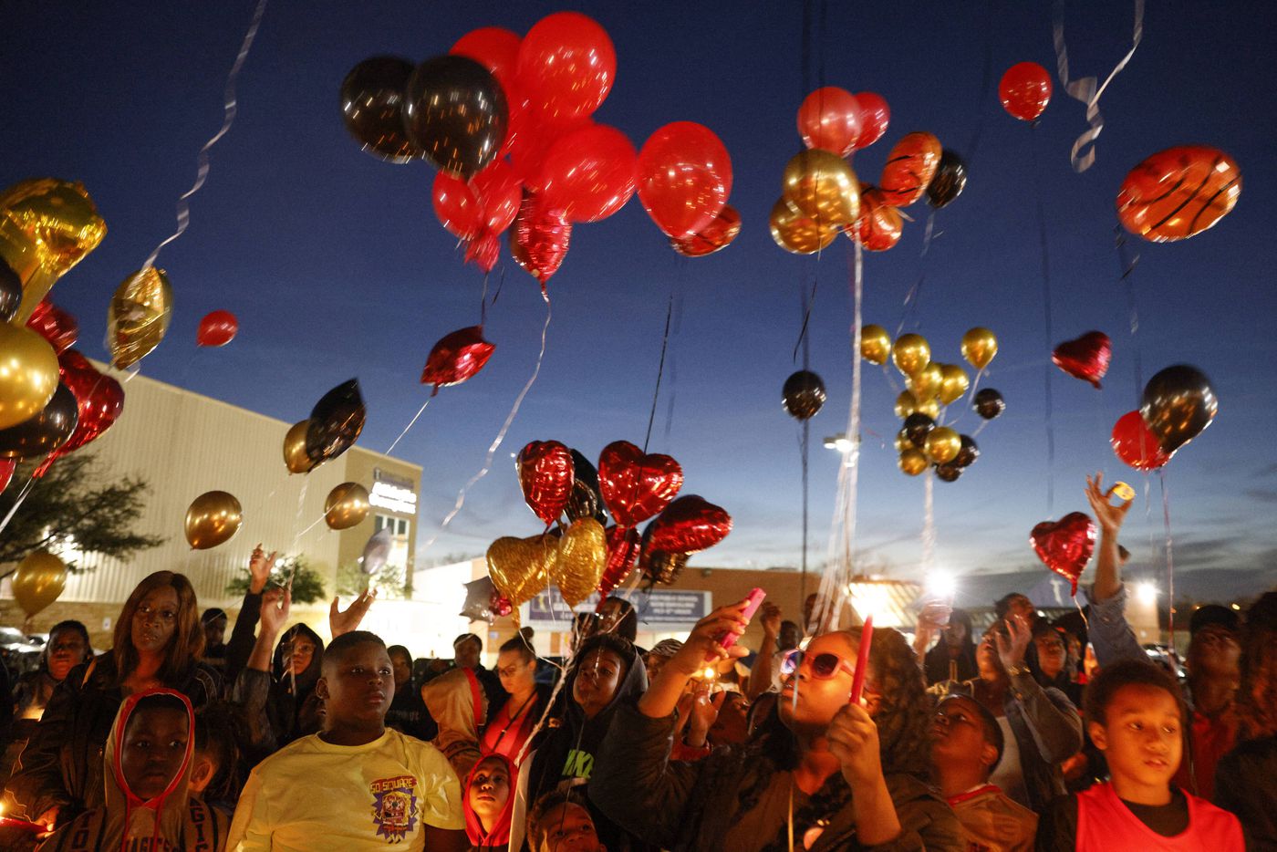 People release balloons in memory of 11-year-old De’Evan McFall outside Trinity Basin...