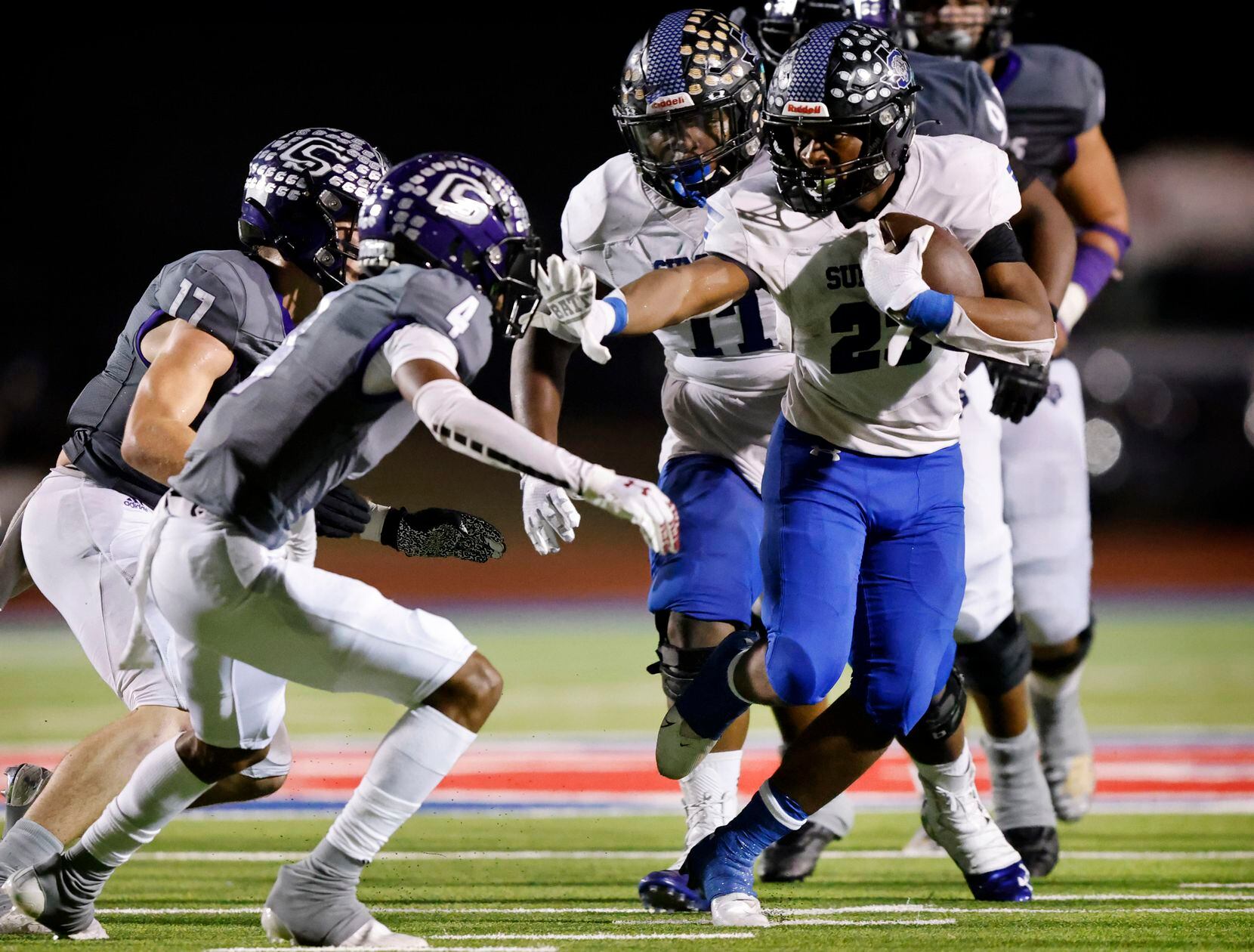 Mansfield Summit running back Orlando Scales (23) gives a stiff arm to College Station...