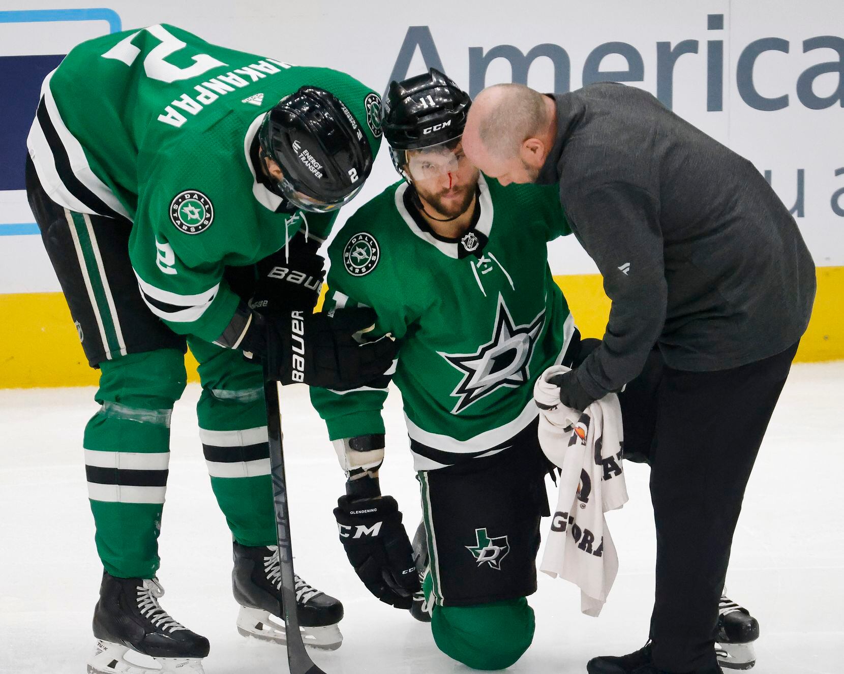 Dallas Stars center Luke Glendening (11) is slow to get to his feet after being hit in the...