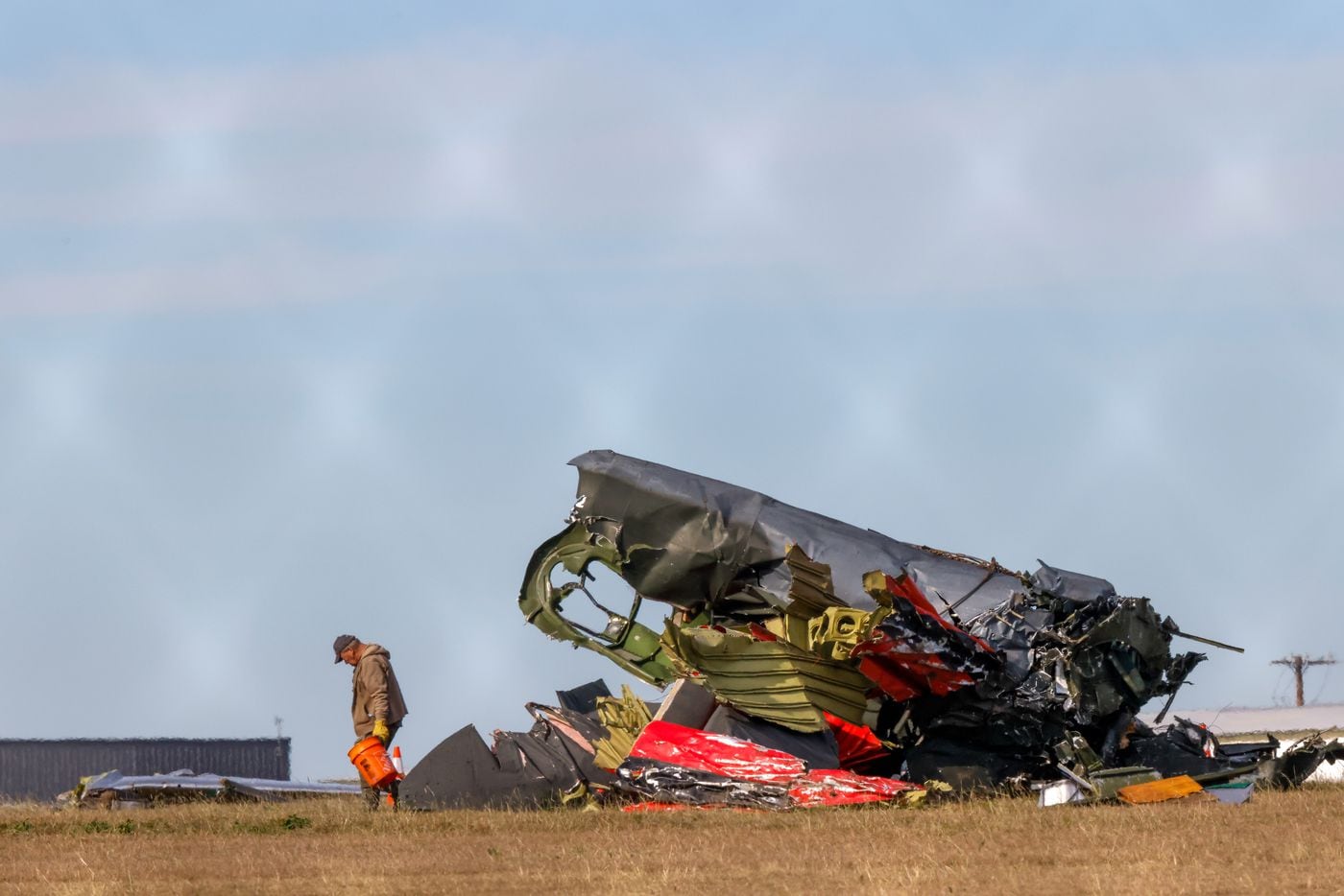 Much of the debris around a damaged plane at the Dallas Executive Airport is removed  on...