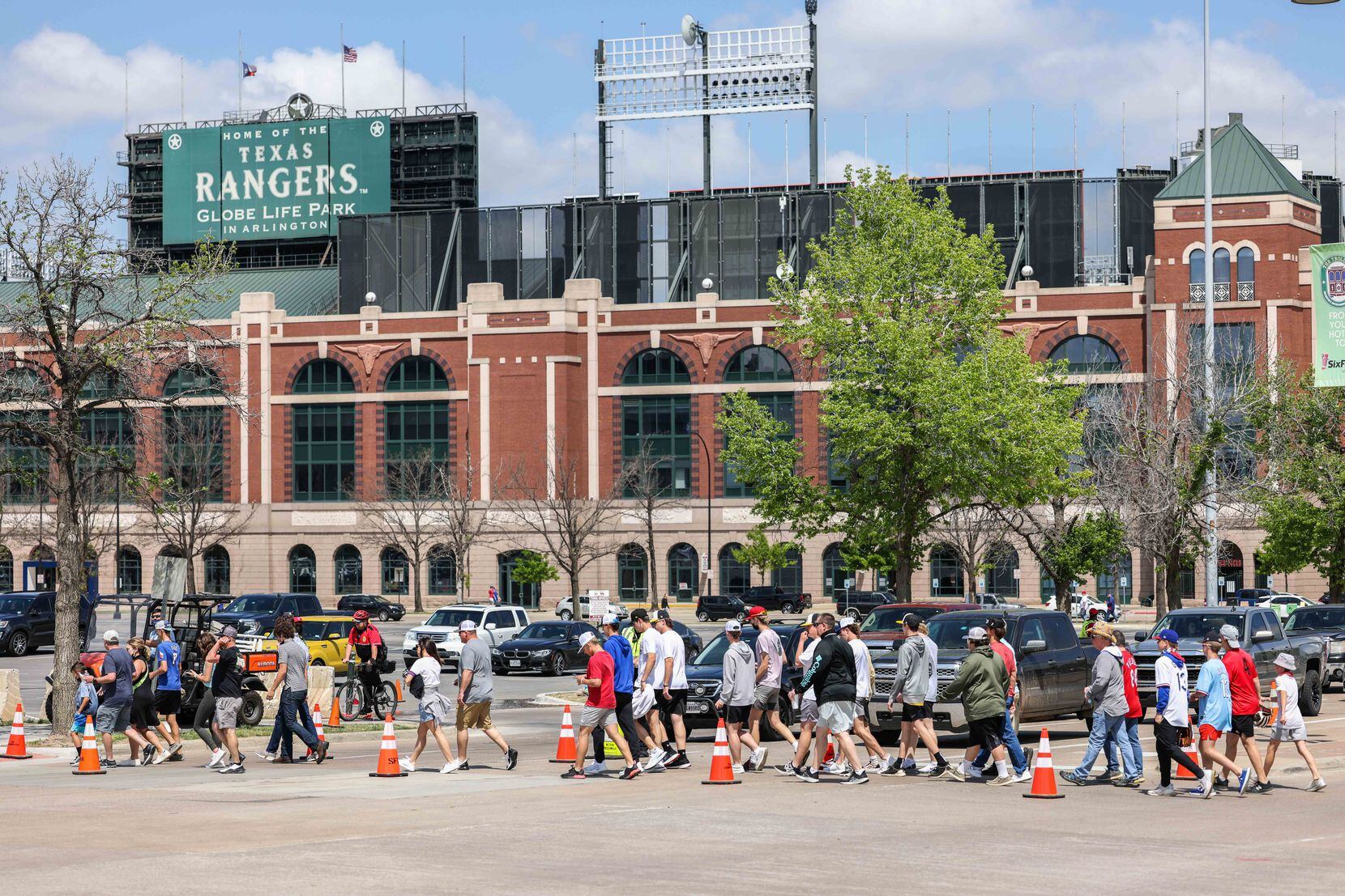 Fans walk to the Globe Life Field entrance to attend the game between Texas Rangers and Toronto Blue Jays on opening day in Arlington, Texas on Monday, April 5, 2021. (Lola Gomez/The Dallas Morning News)