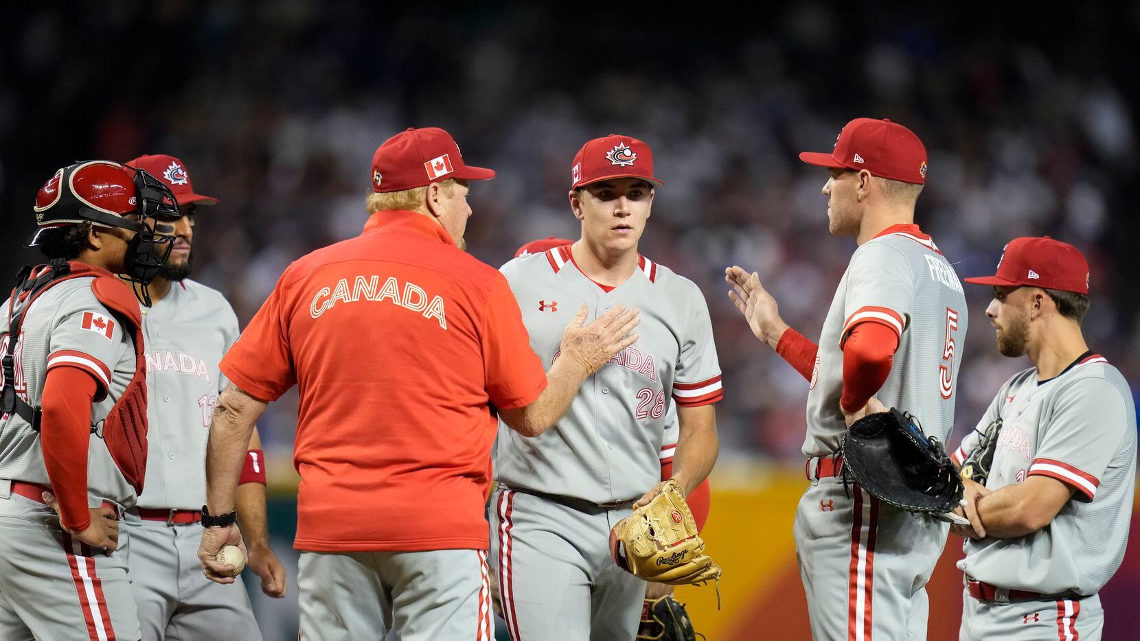 Canada pitcher Mitch Bratt, center right, exits during the first inning of a World Baseball...