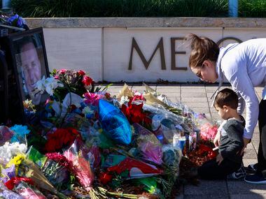 Michael Richard Casco and his mother, Katie Casco, shared a moment in front of the memorial for Officer Richard Houston at Mesquite police headquarters on Monday, Dec. 6, 2021.