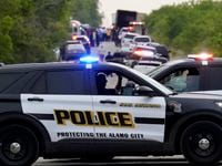 Police block the scene where a semitrailer with multiple dead bodies was discovered, Monday,...