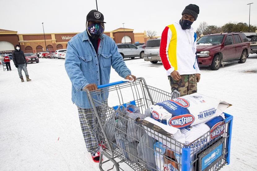 Reuben Brown (left) and Dekaetron McCalley wheel charcoal and a grill they bought at Walmart...