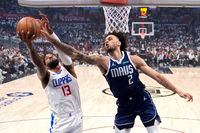 Los Angeles Clippers forward Paul George, left, and Dallas Mavericks center Dereck Lively II...