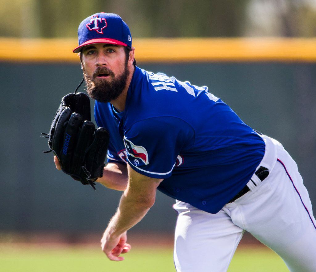 Texas Rangers starting pitcher Cole Hamels (35) warms up his arm during a spring training...