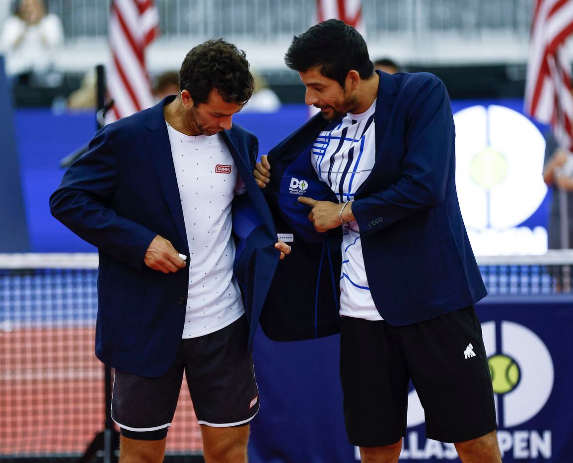 Marcelo Arevalo, right, points out the Dallas Open Champion logo embroidered in the lining...