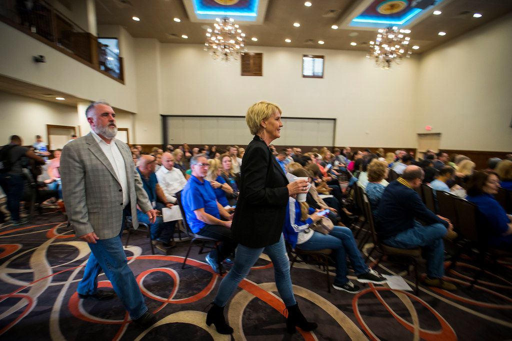 Environmental activist Erin Brockovich (center) and water consultant Bob Bowcock arrive for a town hall style meeting at Frisco Celebration Hall on Thursday.