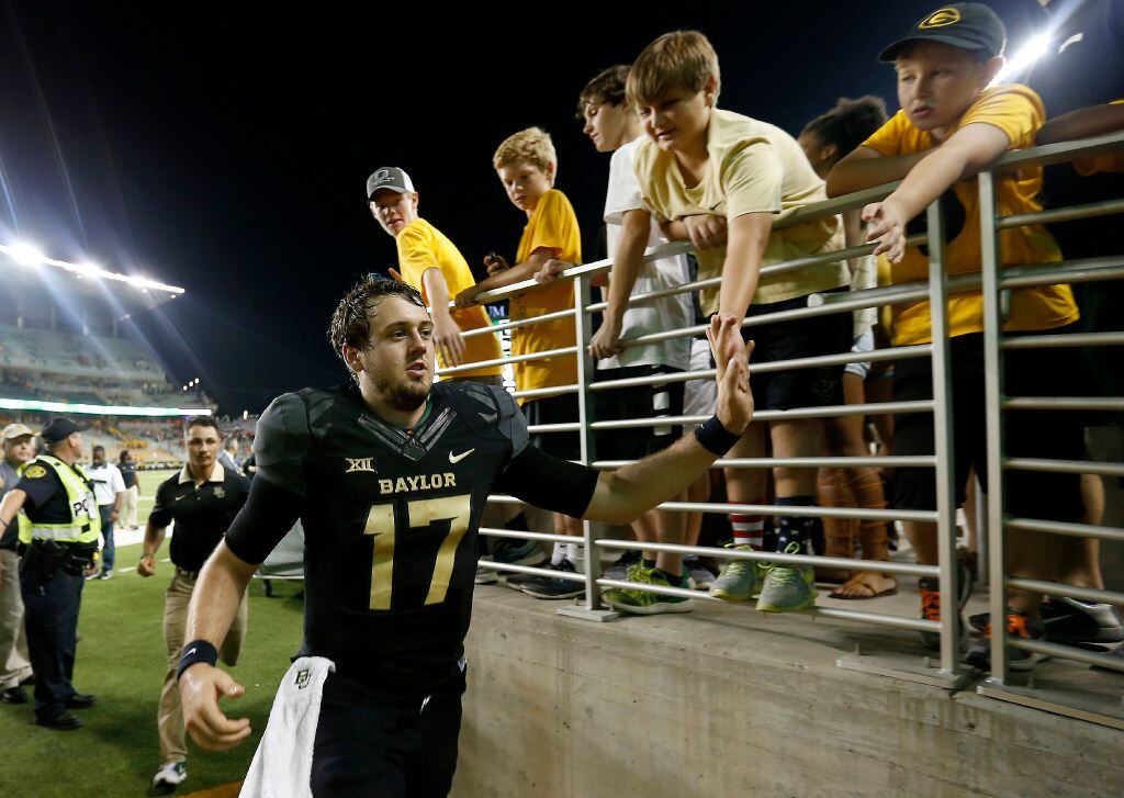 Baylor quarterback Seth Russell (17) celebrates a 35-24 win over Oklahoma State with fans at...