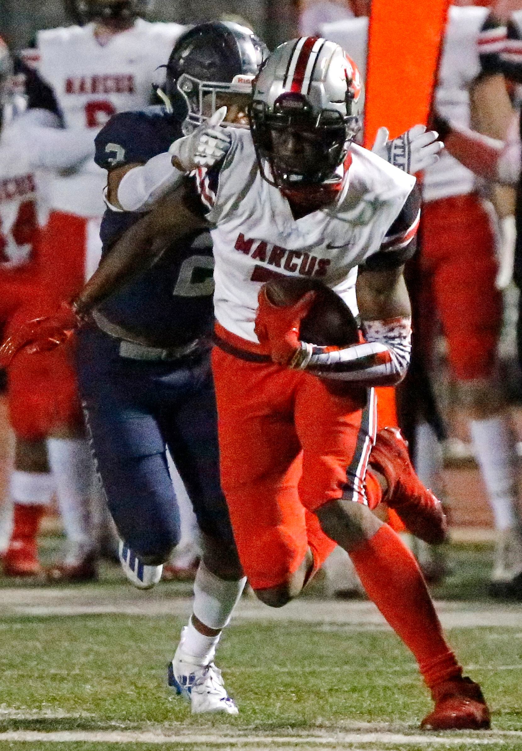 Flower Mound Marcus wide receiver J.Michael Sturdivant (7) is tackled by Flower Mound High...