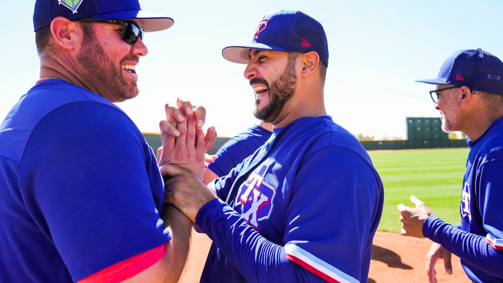 Texas Rangers pitcher Martin Perez (center) laughs with Special Assistant to the General...