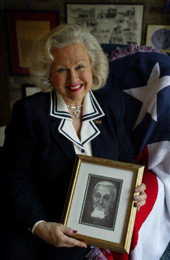 Dallas native Pat Spackey  holds a portrait of her great-great grandfather, Dr. Charles...