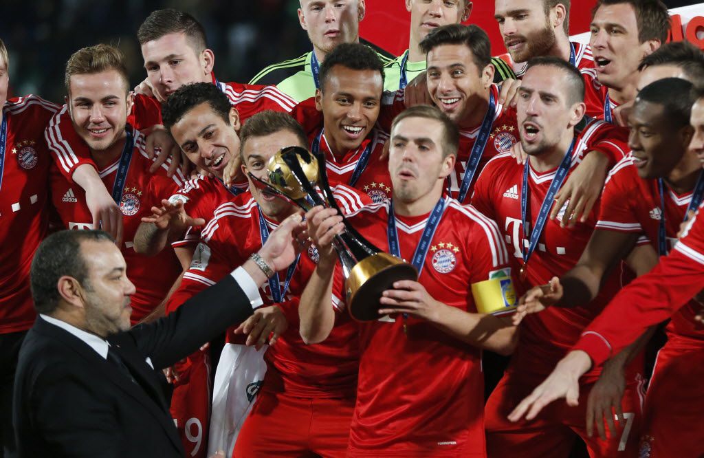 Moroccan King Mohammed VI hands over the trophy to Bayern's team captain Philipp Lahm after...