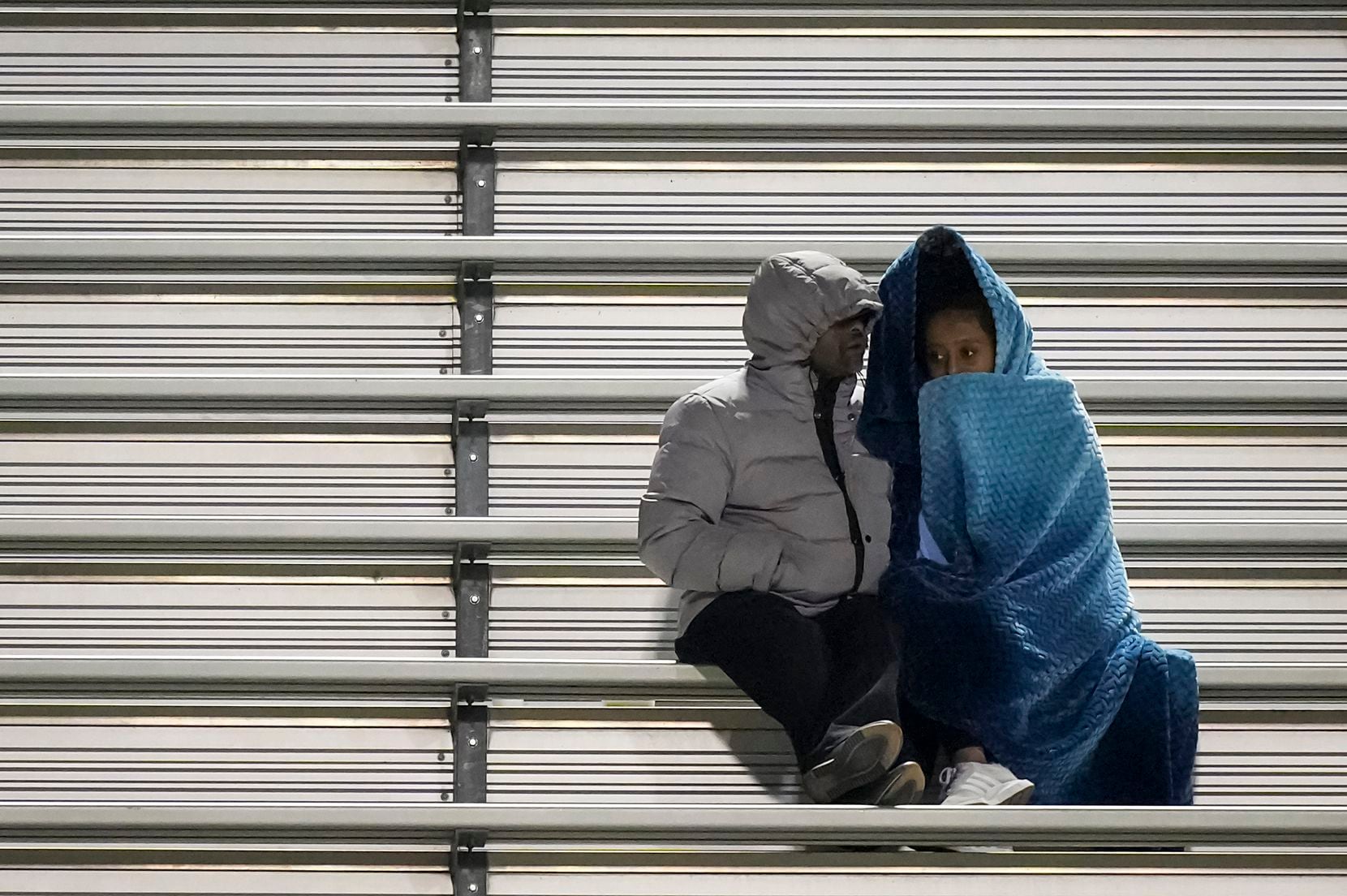 Fans on the Flower Mound side bundle up against a chilly evening during the second half of a...