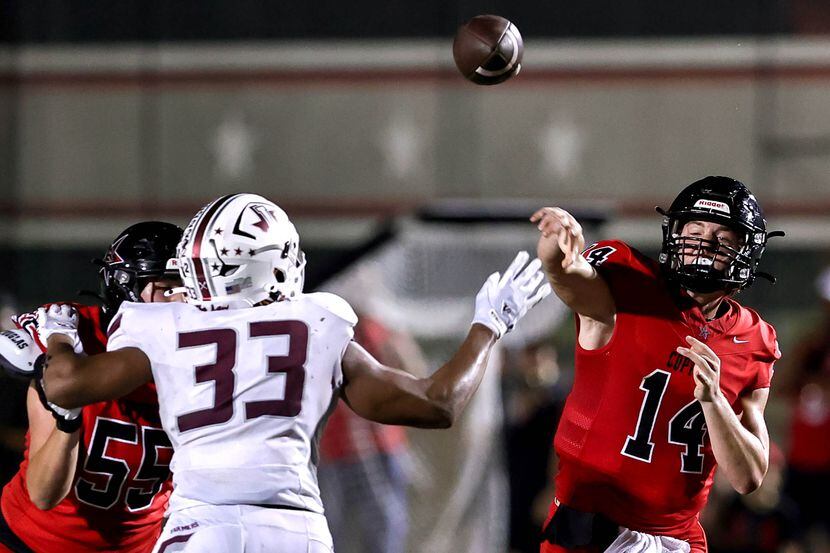 Coppell quarterback Edward Griffin (14) gets the pass off over Lewisville defensive lineman...