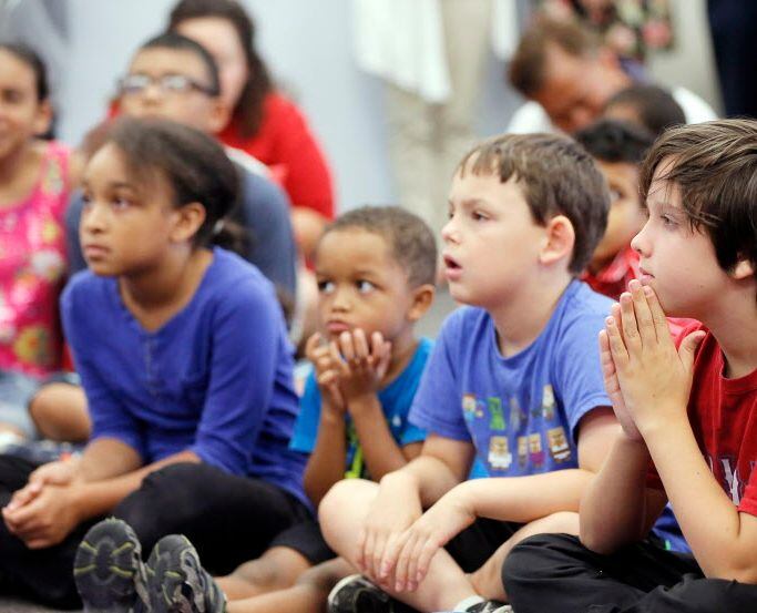 Children listen during an event at the Arlington public library.