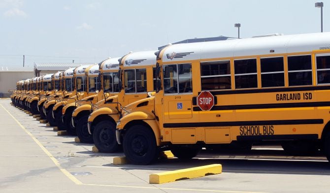 Garland ISD buses line up outside.