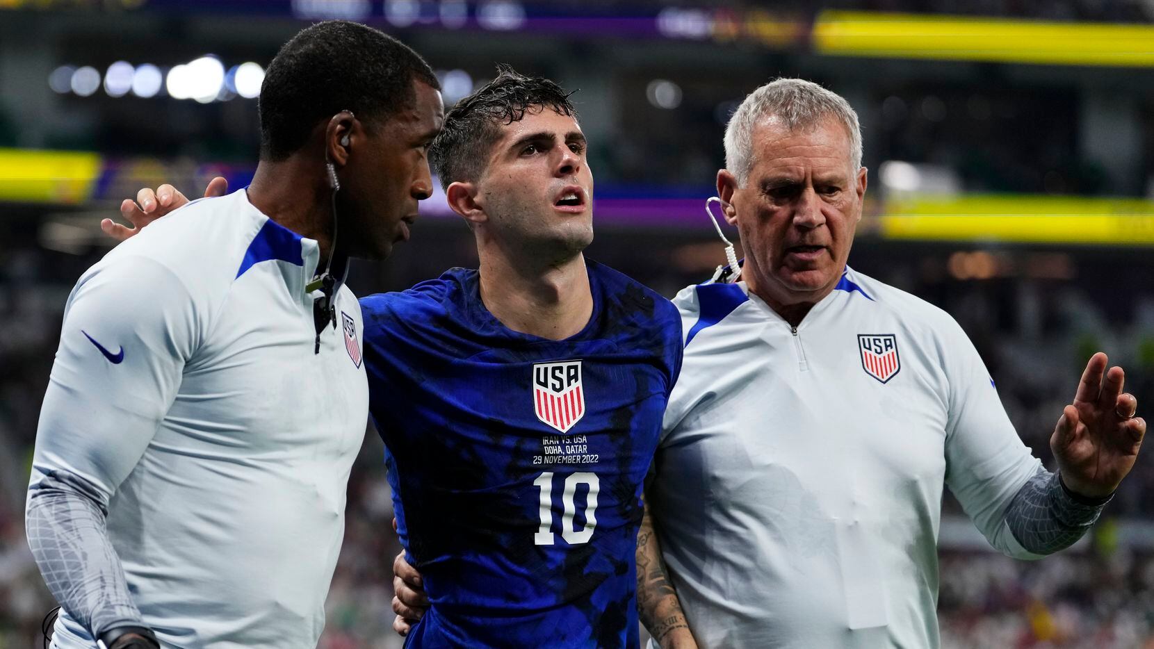 Christian Pulisic of the United States is helped off the pitch after suffering an injury...