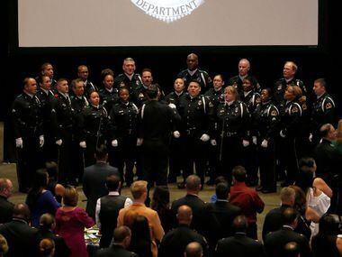 The Dallas Police Choir sings the national anthem during the awards ceremony at American...