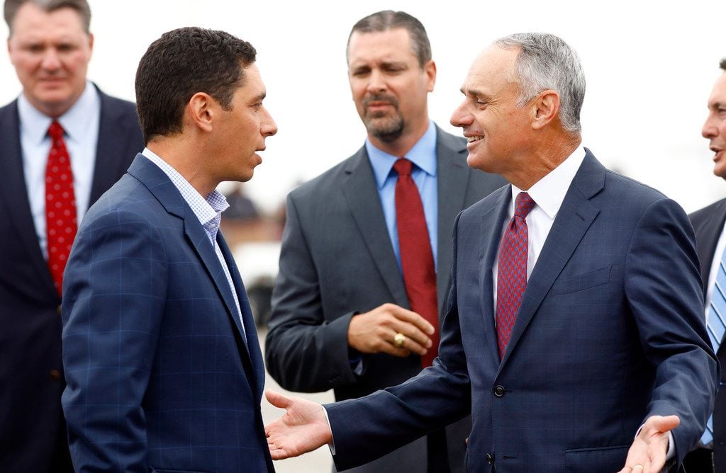 MLB Commissioner Rob Manfred (right) visits with Texas Rangers general manager Jon Daniels...