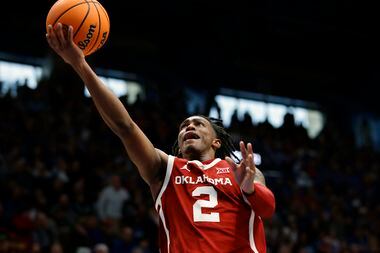 Oklahoma guard Javian McCollum scores during the second half of an NCAA college basketball...
