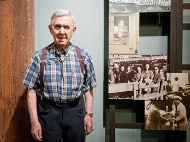 Mike Jacobs poses next to a photo of himself in an exhibit at the Dallas Holocaust Museum/Center for Education and Tolerance. He organized and was president of the Holocaust Survivors in Dallas.