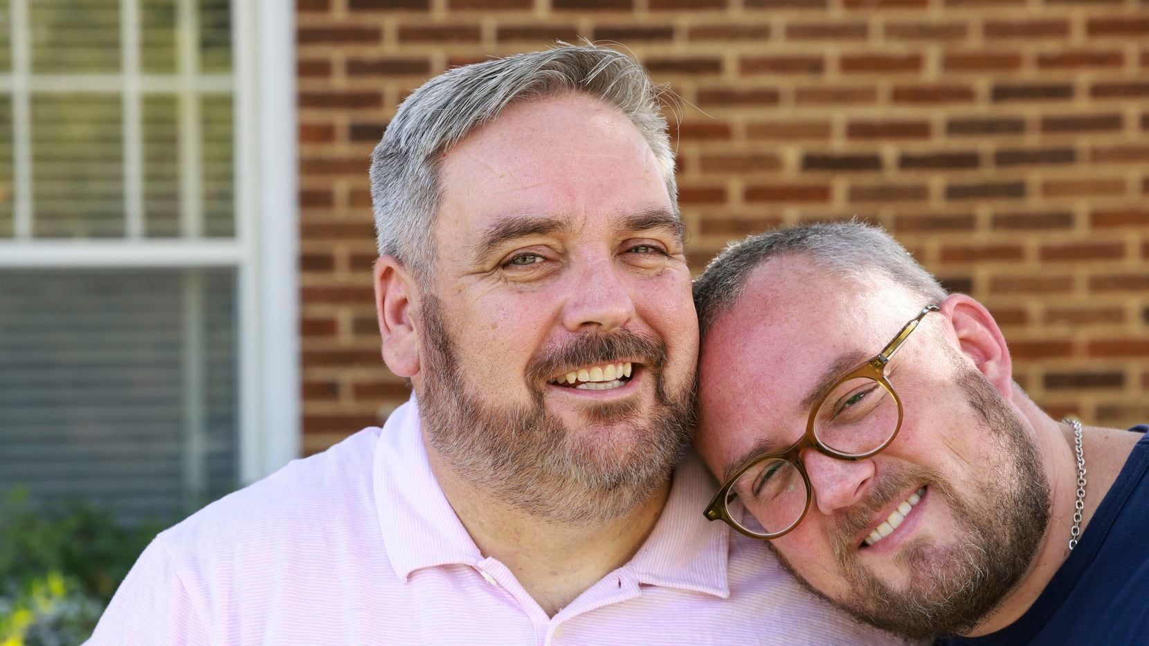 James Miller, 48, and Ricky Morrison, 40, pose for a portrait together at their home,...