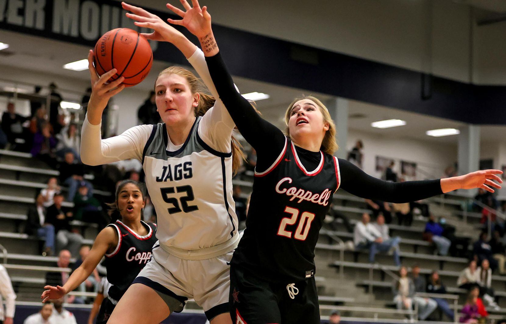Flower Mound center Abbie Boutilier (52) goes for a loose ball against Coppell guard...