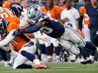Dallas Cowboys linebacker Devin Harper (50) tackles Denver Broncos quarterback Josh Johnson...