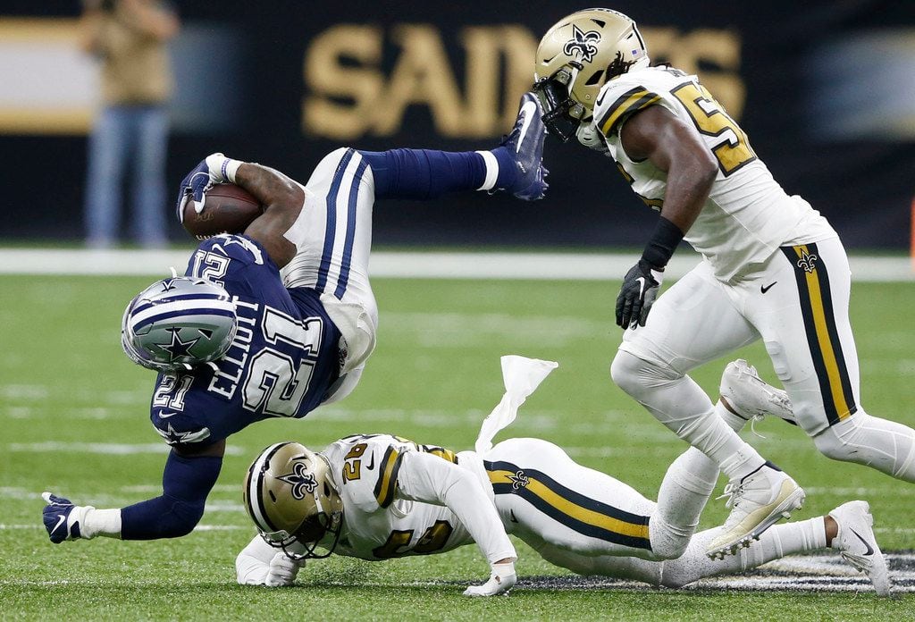 Dallas Cowboys running back Ezekiel Elliott (21) is tackled by New Orleans Saints cornerback...