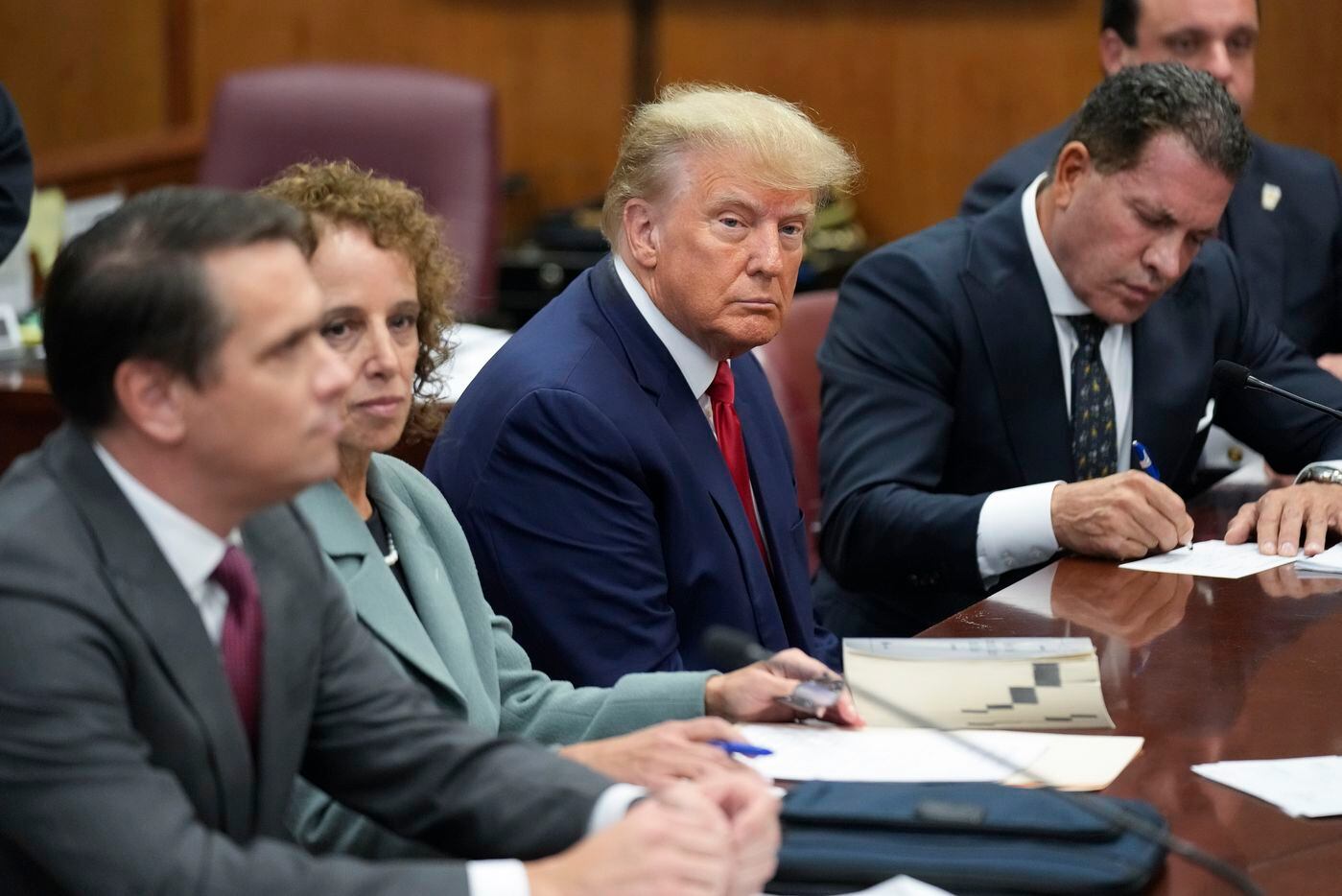 Former President Donald Trump sits at the defense table with his legal team in a Manhattan...