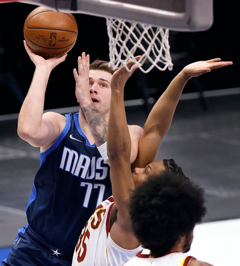Dallas Mavericks guard Luka Doncic (77) puts up a first quarter shot over Cleveland Cavaliers forward Isaac Okoro (35) at the American Airlines Center in Dallas, Friday, May 7, 2021. (Tom Fox/The Dallas Morning News)